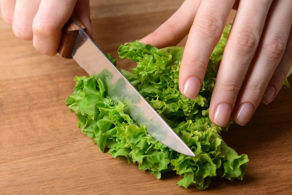 Chopped green lettuce  on wooden board close-up — Stock Photo, Image