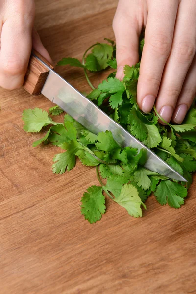 Chopped cilantro on wooden board close-up — Stock Photo, Image