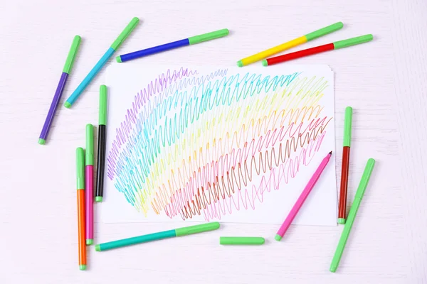 Kids drawing and colored pencils on wooden table — Stock Photo, Image