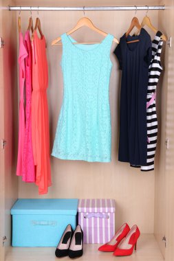 Female clothes on hangers in wardrobe