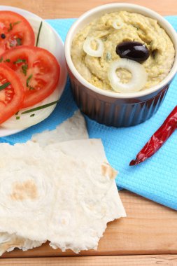 Bir kase domatesli taze humus.