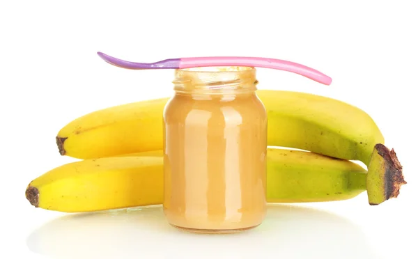 Frasco com banana baby food e colher isolada em branco — Fotografia de Stock