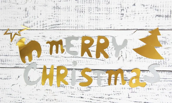Merry Christmas lettering on wooden table close-up — Stock Photo, Image