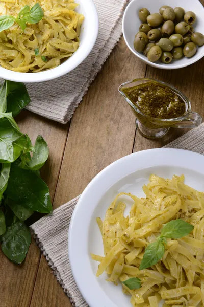 Delicious pasta with pesto on plate on table close-up — Stock Photo, Image