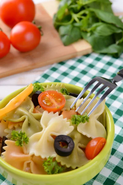 Delicious pasta with tomatoes on plate on table close-up — Stock Photo, Image