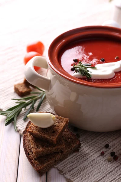 Tasty tomato soup and vegetables on wooden table — ストック写真