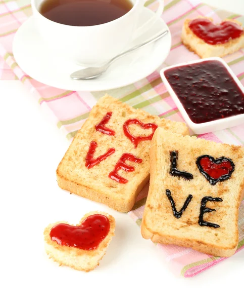 Delicious toast with jam and cup of tea on table close-up — Stock Photo, Image