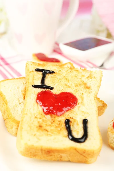 Delicious toast with jam and cup of tea on table close-up — Stock Photo, Image