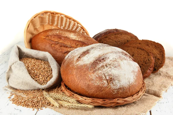 Rye bread with grains on sackcloth on table on gray background — Stock Photo, Image