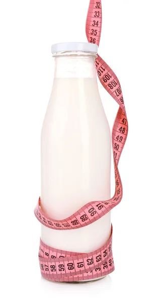 Bottle of milk with measuring tape isolated on white — Stock Photo, Image