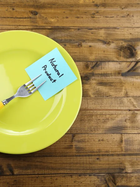 Note paper with message  attached to fork, on plate, on color wooden background — Stock Photo, Image