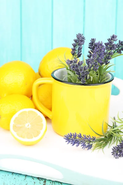 Still life with fresh lemons and lavender on blue background — Stock Photo, Image