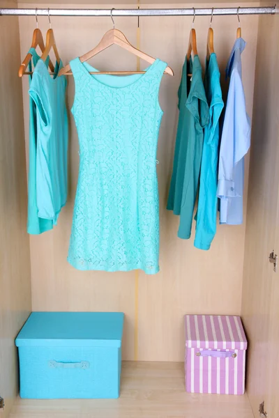 Female clothes on hangers in wardrobe — Stok fotoğraf