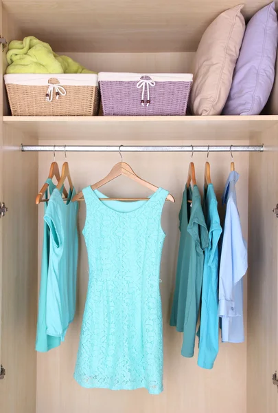 Female clothes on hangers in wardrobe — Stockfoto