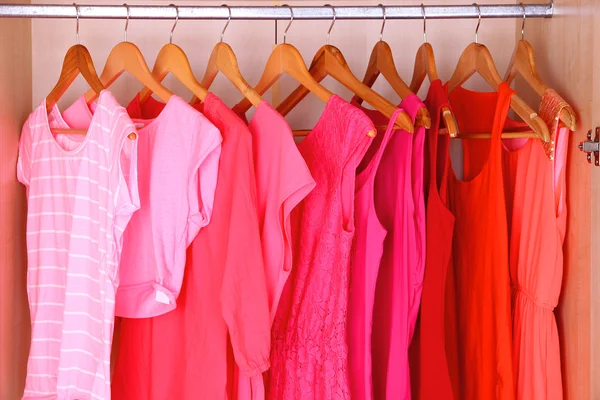 Female clothes on hangers in wardrobe — Stok fotoğraf