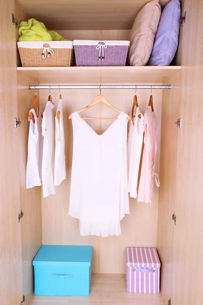 Female clothes on hangers in wardrobe — ストック写真