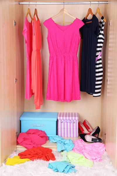 Female clothes on hangers in wardrobe — Stok fotoğraf