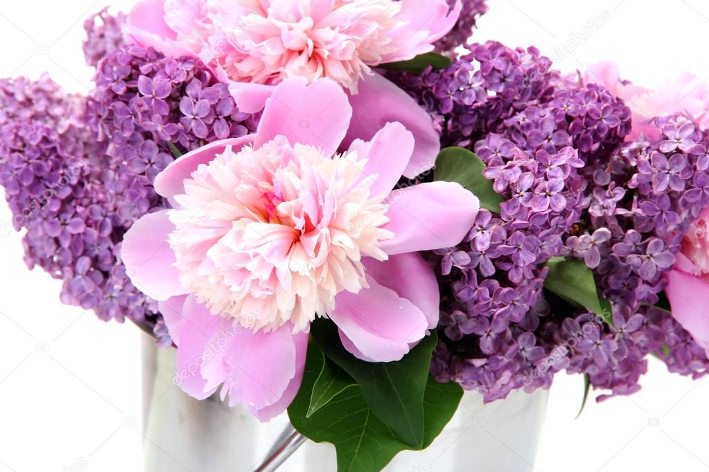 Beautiful lilac and peonies flowers in metal bucket isolated on white