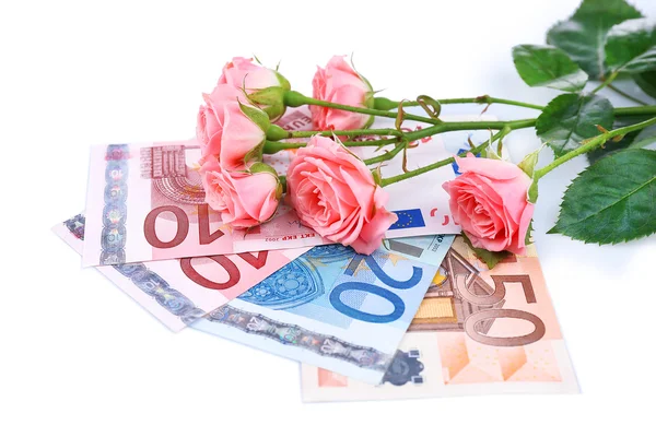 Mooie rozen en geld, geïsoleerd op wit — Stockfoto