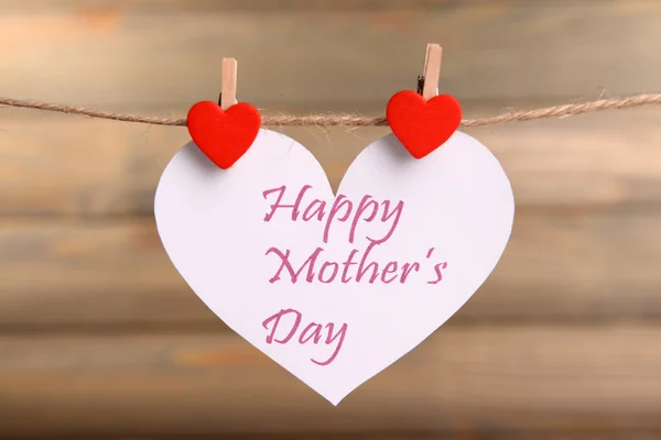 Happy Mothers Day message written on paper heart on brown background — Stock Photo, Image