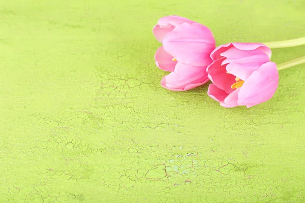 Beautiful pink tulips on wooden table — Stock Photo, Image