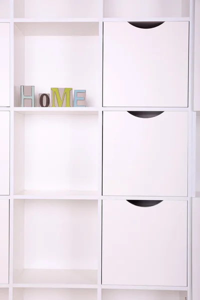 Shelves with decorative letter close up — Stock Photo, Image