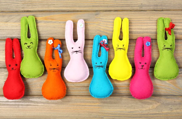 Composition with funny handmade Easter rabbits on wooden background — Stock Photo, Image