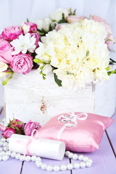 Beautiful wedding composition with flowers on table on fabric background — Stock Photo, Image