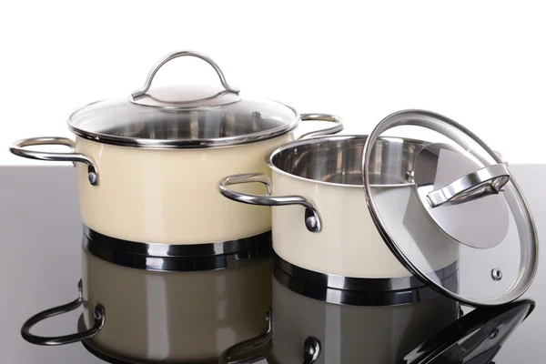 Pans on table on white background — Stock Photo, Image