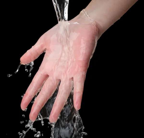 Human hand with water splashing on them on black background — Stock Photo, Image