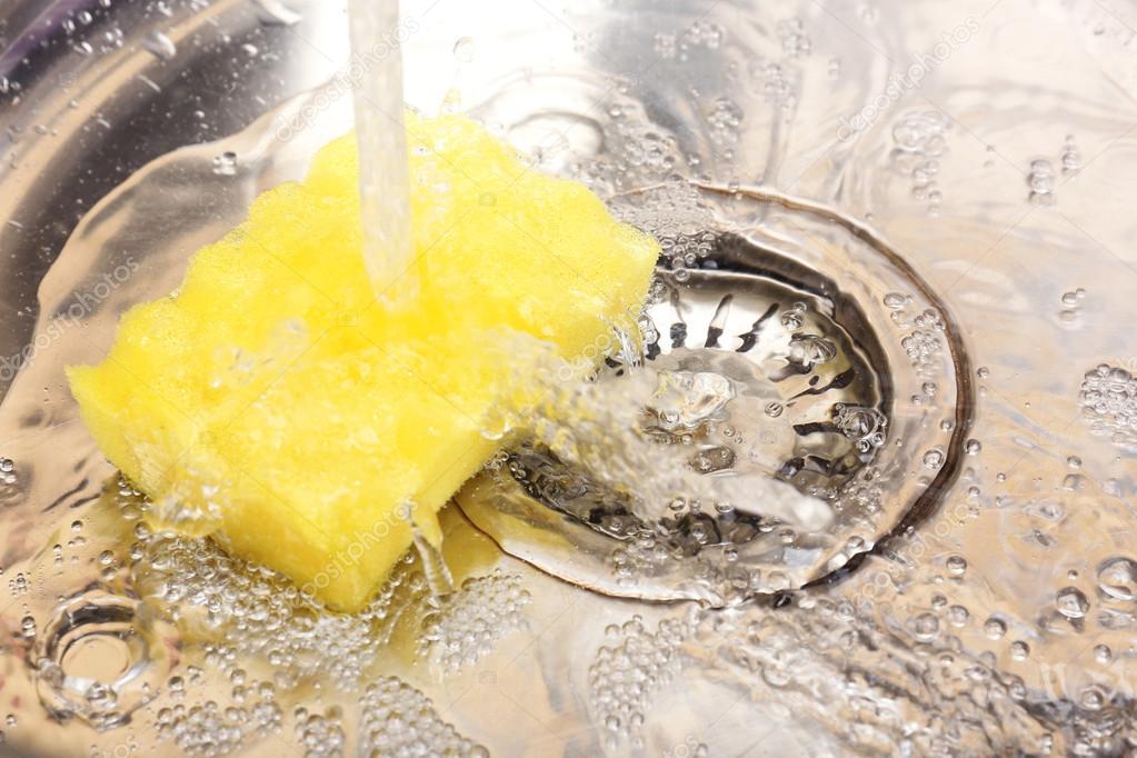 Water flowing down hole in kitchen sink Stock Photo by ©belchonock 44420095