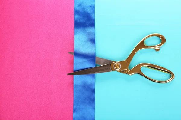 Scissors on color fabric background — Stock Photo, Image