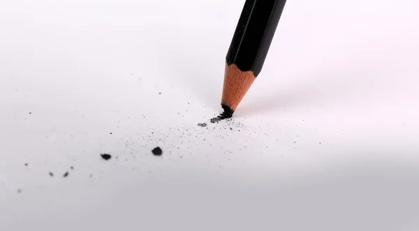 Breaking pencil on paper, close up — Stock Photo, Image