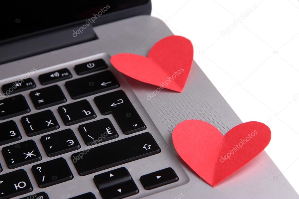 Red hearts on computer keyboard close up