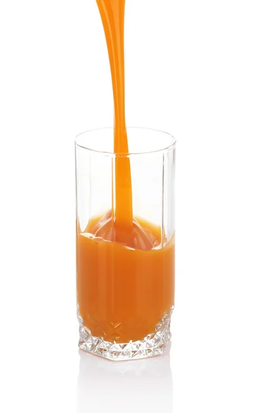 Juice pouring into glass isolated on white — Stock Photo, Image