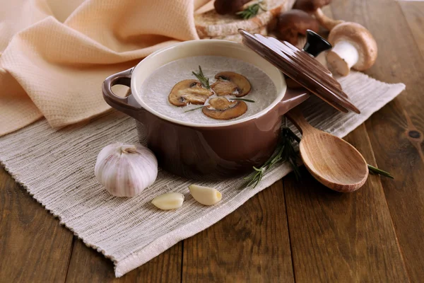 Mushroom soup in pot, on wooden background — Stock Photo, Image