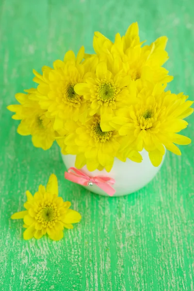 Beautiful chrysanthemum flowers in vase on wooden table close-up — Stock Photo, Image