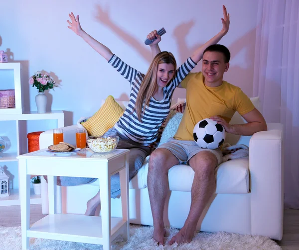 Young couple watching television at home of blacking-out — Stock Photo, Image