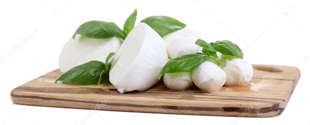 Tasty mozzarella with basil on wooden board isolated on white