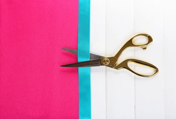 Scissors on color fabric background — Stock Photo, Image