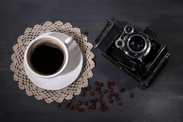 Taza de café, cámara vintage y viejas fotos en blanco, sobre fondo de madera — Foto de Stock