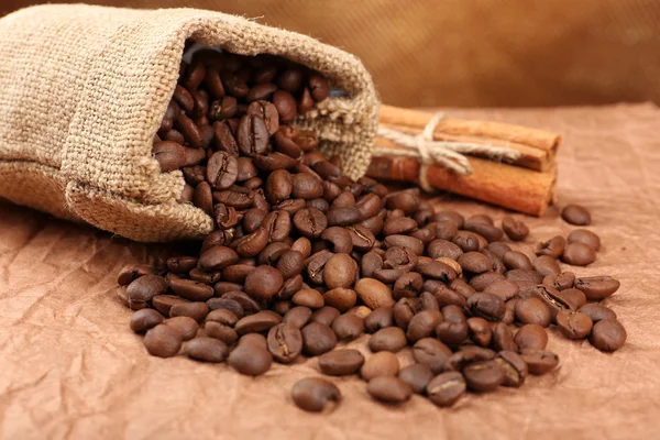 Coffee beans in sack on table close-up — Stock Photo, Image