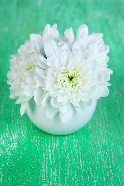 Beautiful chrysanthemum flowers in vase on wooden table close-up — Stock Photo, Image