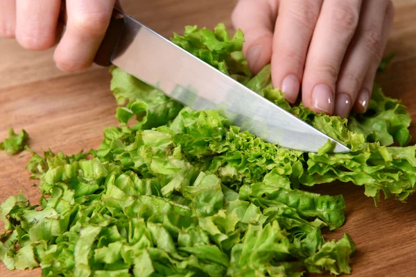 Chopped green lettuce  on wooden board close-up — Stock Photo, Image