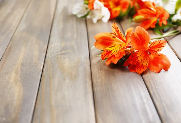 Beautiful Alstroemeria flowers on wooden table — Stock Photo, Image