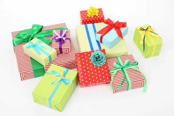 Many colorful presents with luxury ribbons  on color carpet background — Stock Photo, Image