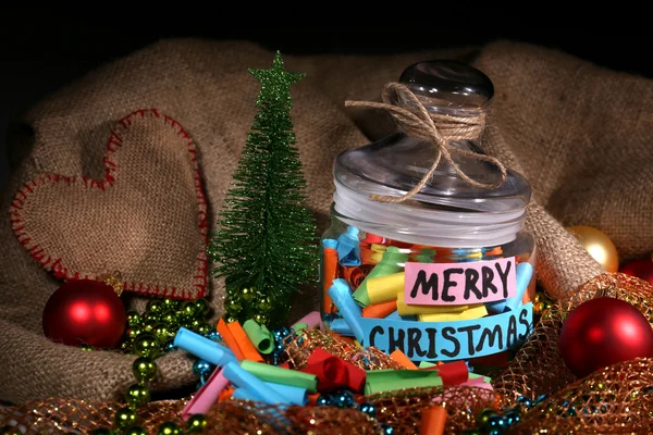 Dreams written on color  rolled paper in glass jar, on sackcloth and fabric background — Stock Photo, Image