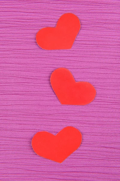 Paper hearts on purple background — Stock Photo, Image