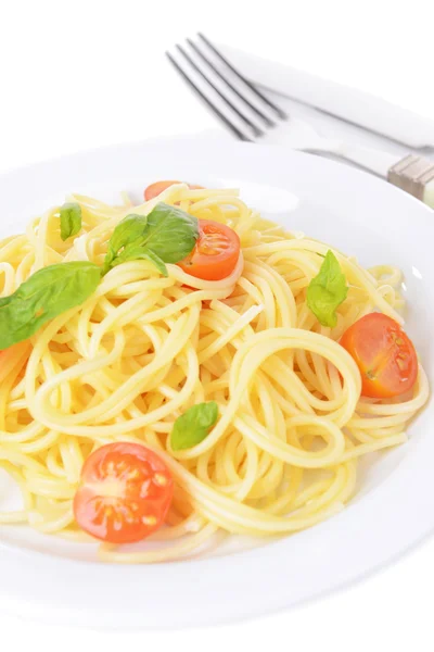 Delicious spaghetti with tomatoes on plate close-up — Stock Photo, Image