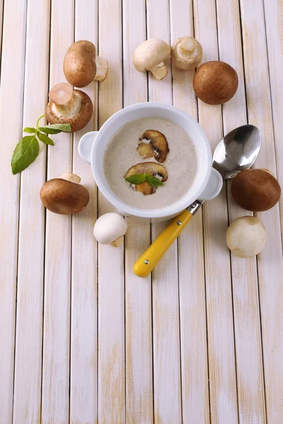 Pilzsuppe im weißen Topf auf hölzernem Hintergrund — Stockfoto